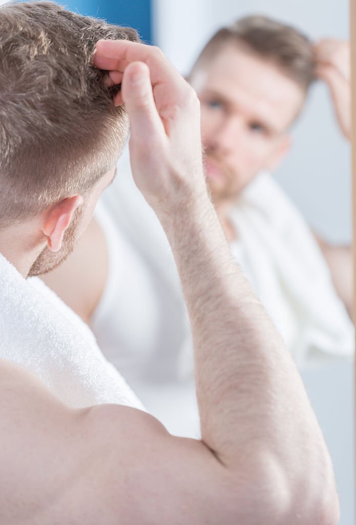 Image of narcissistic man in the bathroom